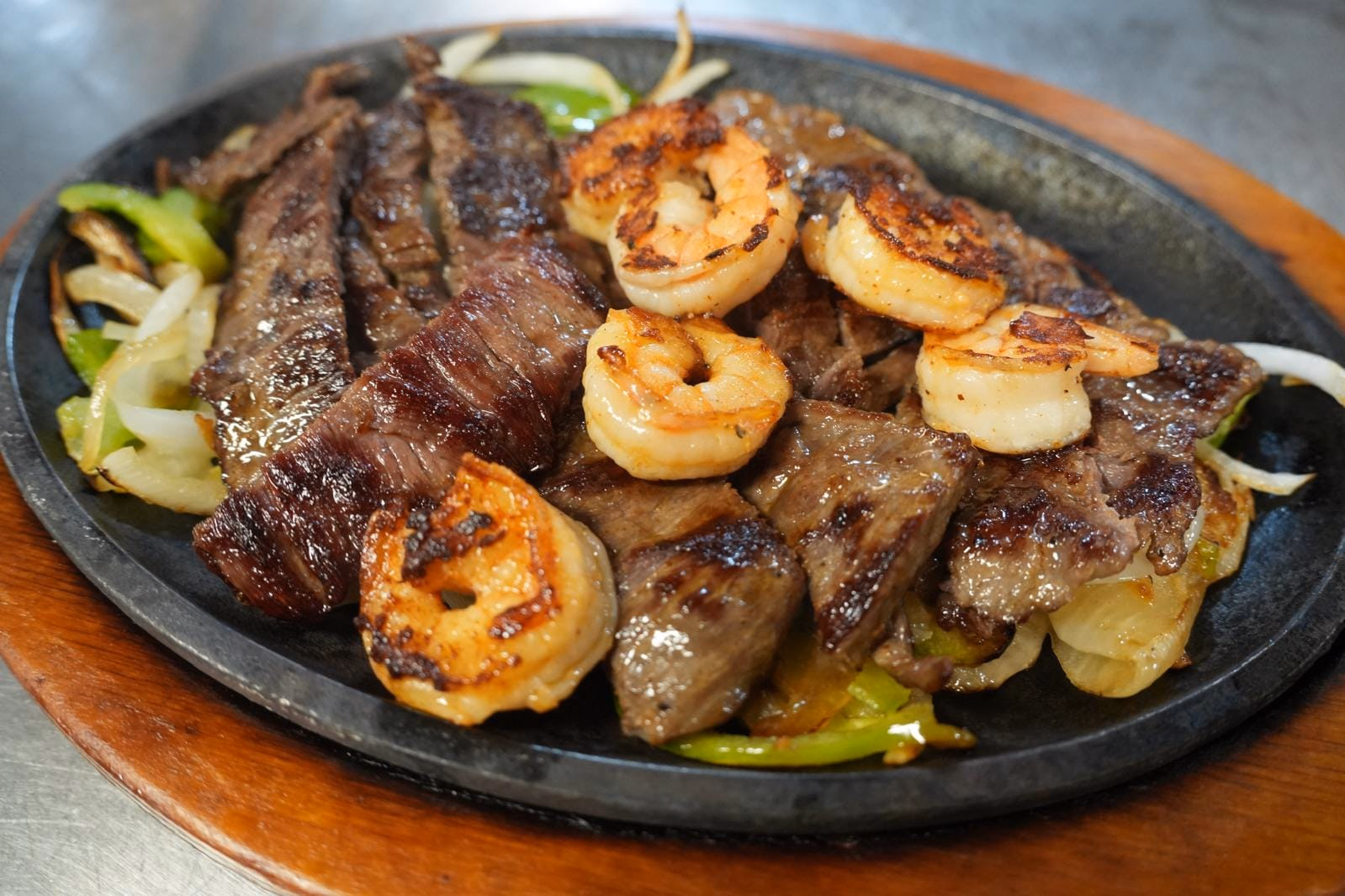 Taqueria Garibaldi #40 beef fajita and shrimp on a sizzling skillet